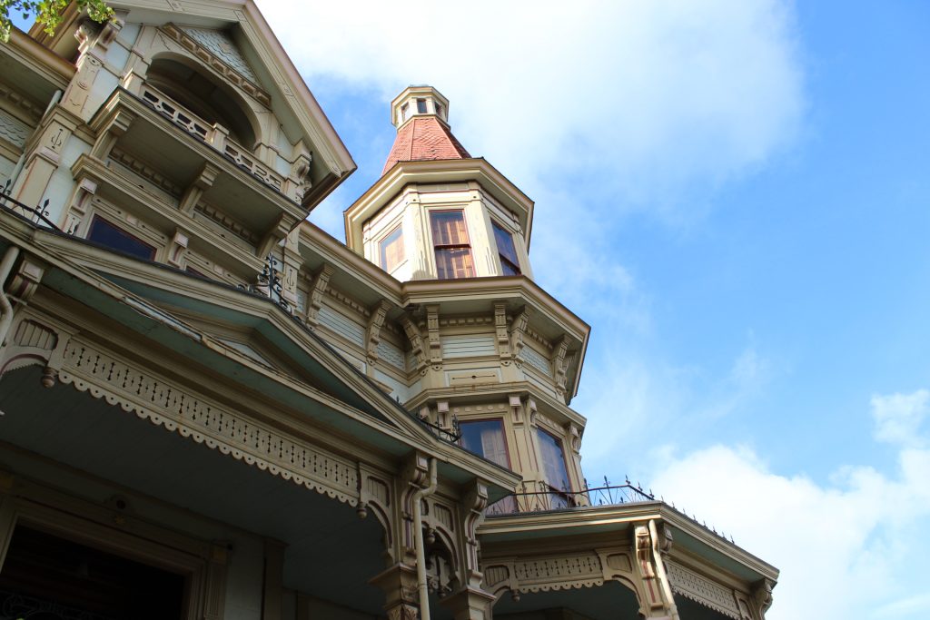 Opulent exterior of the Flavel House, a Victorian mansion in Astoria, Oregon.