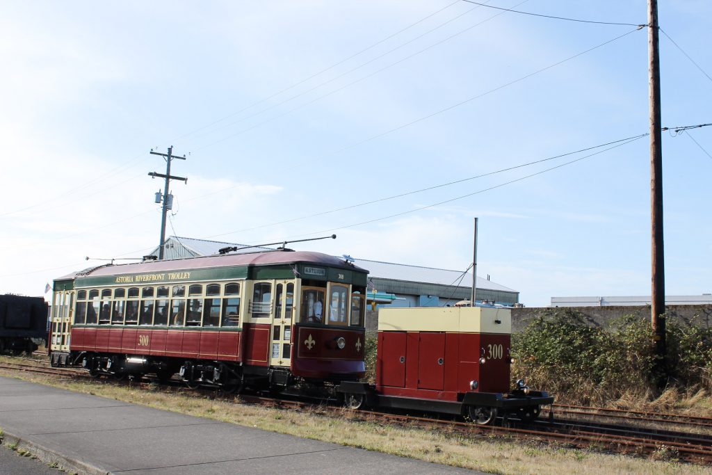 The Astoria Riverfront Trolley traveling along a set of tracks near the port.